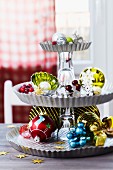 Arrangement of Christmas decorations on cake stand upcycled from tart tins