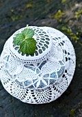 Pebbles covered in white lace doilies
