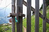 Wooden gate in wire fence in the Alps