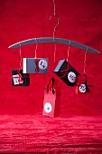 Hand-crafted advent calendar of small paper boxes strung on coat hanger