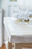 Dining table decorated with white lace ribbon