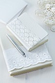 Notebooks with jackets decorated with lace ribbon