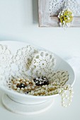 China jewellery dish lined with crocheted doily