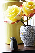 Yellow roses and penguin ornament