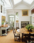 Landhausküche mit Deckenfenstern & Essbereich mit ovalem Holztisch & Stühlen