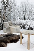 Beanbag, fur rug and stool with fur cover in snow