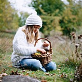 Girl with a basket in the countryside, Sweden.
