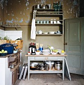 Simple kitchen with peeling paint on walls
