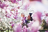 Grandmother and granddaughter amongst magnolia blossom