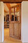 View from foyer into cloakroom through door with glass panels