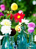 Garden decorated with flowers in glass bottles, Sweden.