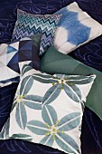 Scatter cushions with green and blue patterns
