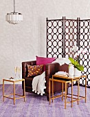 Brown leather armchair, retro nest of side tables and screen with pattern of circles