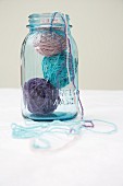 Three balls of wool in glass jar