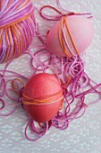 Wrapping dyed Easter eggs with yarn