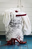 Laundry basket with hand-sewn, toile de jouy fabric cover