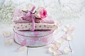 Cake tin decorated with floral fabric and rose