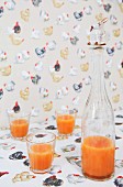 Pattern of hens on tablecloth and wallpaper; stopper with rabbit figurine on bottle of breakfast drink