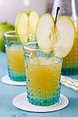 Glasses of apple juice decorated with slice of apple