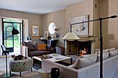 Living room with fireplace, sofas and view of the garden