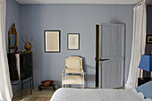 Bedroom with antique furniture and framed wall art