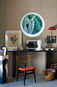 Corner with black console, wooden chair and art objects