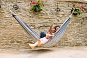 Mother and daughter sitting in a hammock