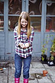 Girl holding garden seeds in her hands