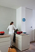 Woman cooking in a minimalist kitchen