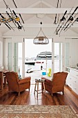 White living room of a small beach house with a view of the water and boats afloat