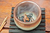 Smoking incense in incense bowl