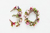 Flower wreaths shaped into the number 30 on white background