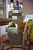 Stack of boxes in retro patterns on wooden Thonet chair