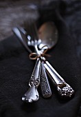 Elegant vintage cutlery tied together with ribbon