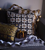 Scatter cushions and Christmas presents draped with paper garlands
