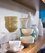 Select collectors' items - vases and bowls on wooden shelf