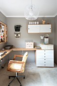 Swivel chair with armrests at corner desk, chest of drawers and wall cabinet on wall painted pale grey