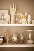 Ornaments and storage jars on white shelves