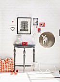 Wall lovingly decorated with pictures above console table