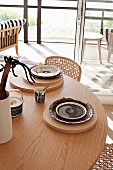 Place settings on wooden boards on round wooden table