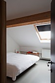 View through open door into attic bedroom