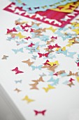 Colourful, butterfly confetti cut out using pattern punch