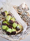 Green marzipan acorns with chocolate cups wrapped as small present