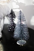 Christmas decorations; silver, glittery, brush-like Christmas trees