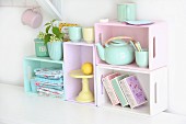 Kitchen shelving modules made from wooden crates painted in pastel shades