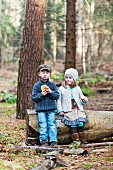 Hansel and Gretel eating bread in woods