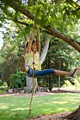 A girl swinging on a rope swing