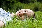 A young woman lying on grass