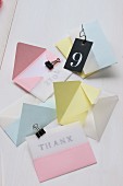 Envelopes of pastel-coloured and transparent paper