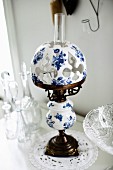 Antique paraffin lamp with china lampshade painted blue and white